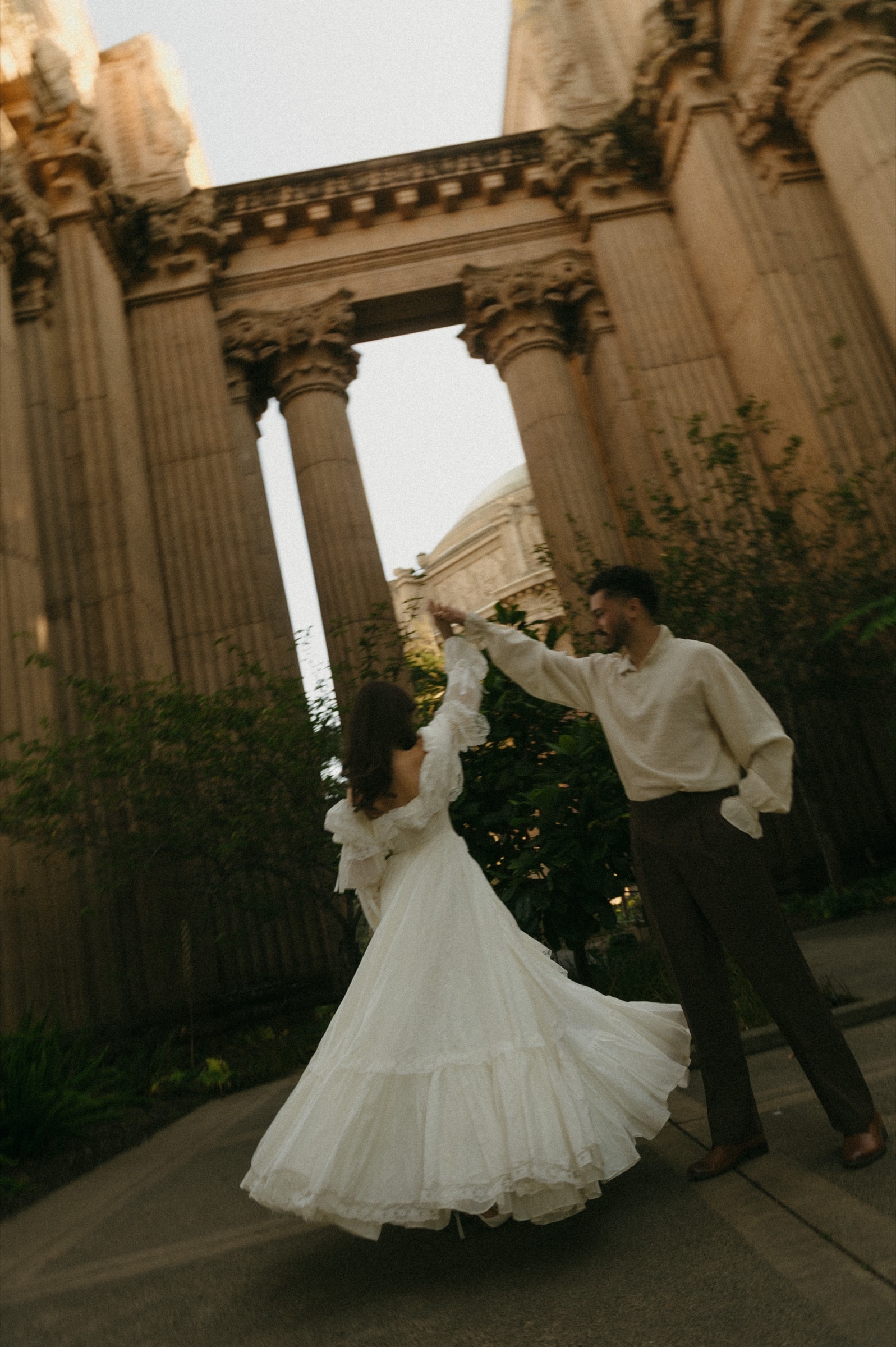 Berkeley and Robin dancing beneath the colonnade at the Palace of Fine Arts, her gown caught mid-twirl