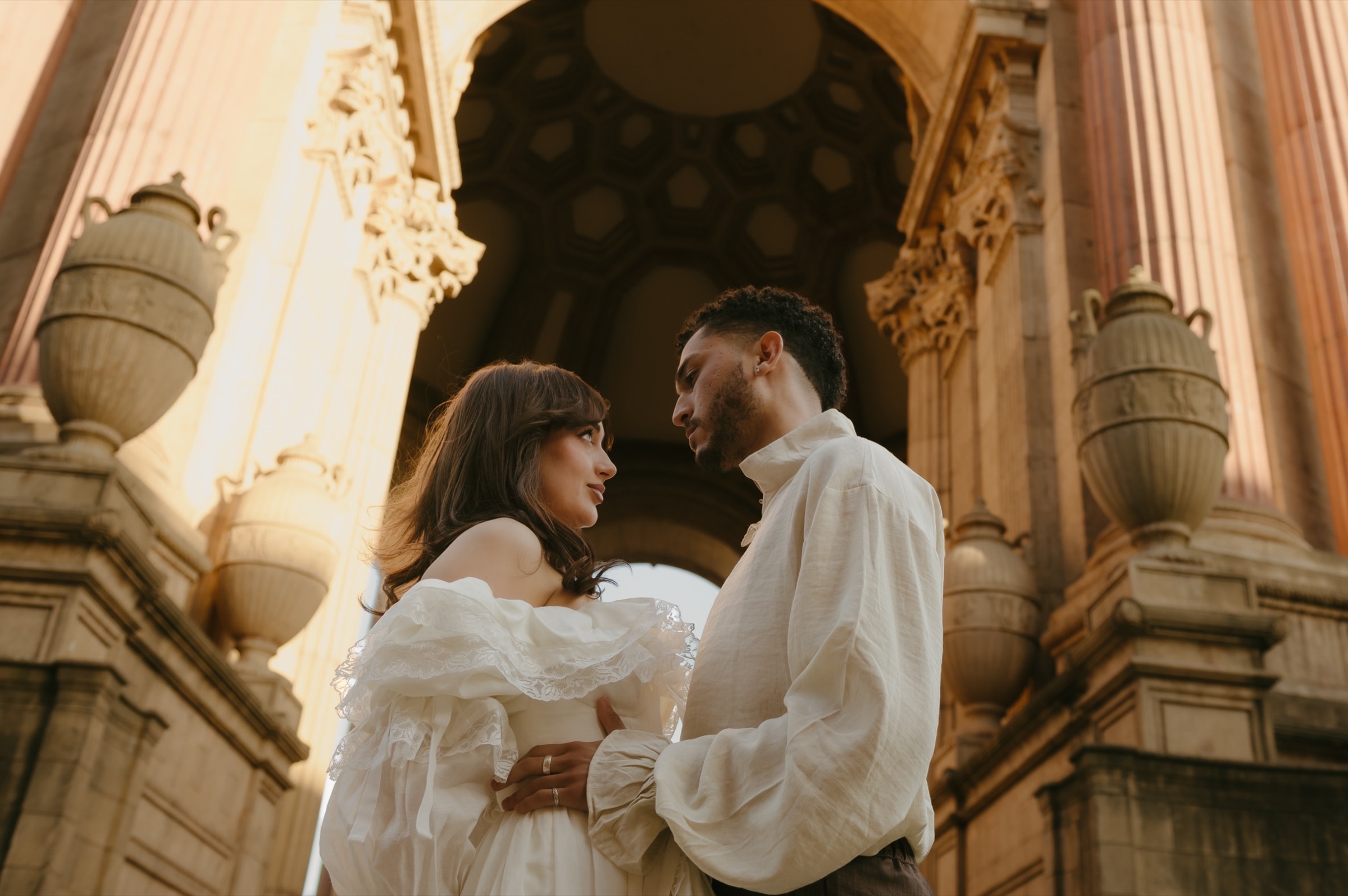 Berkeley and Robin face to face under the Palace of Fine Arts rotunda at golden hour