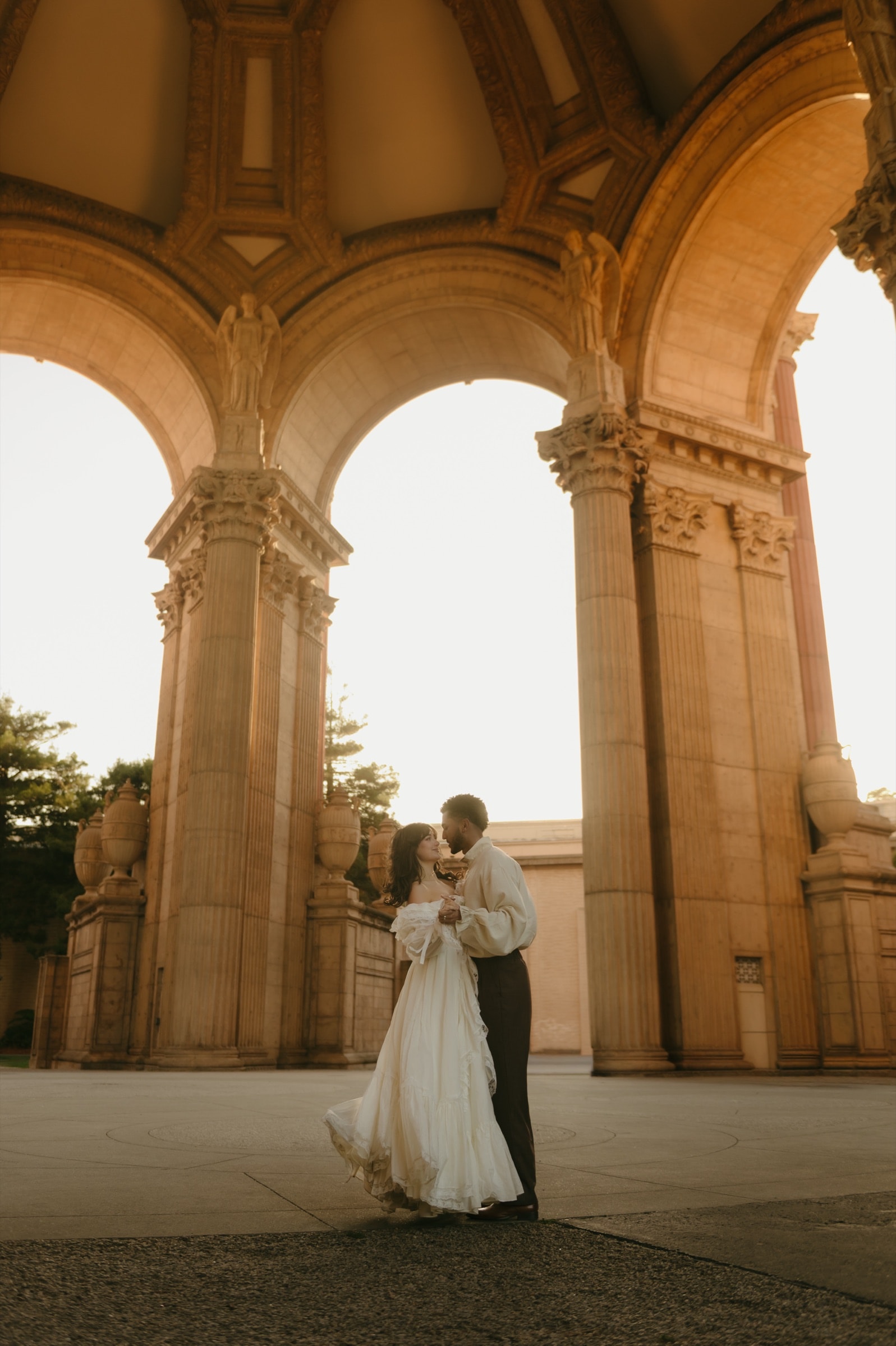 Berkeley and Robin beneath the Palace of Fine Arts dome, framed by its carved columns